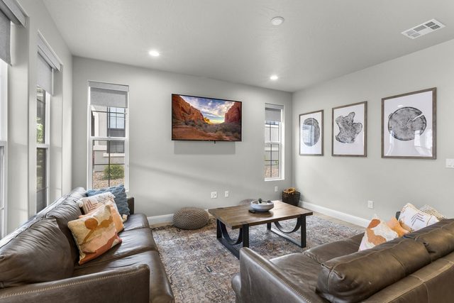 Living room seating area with smart TV and wall art