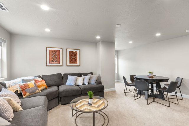Upstairs loft with sectional sofa and round table