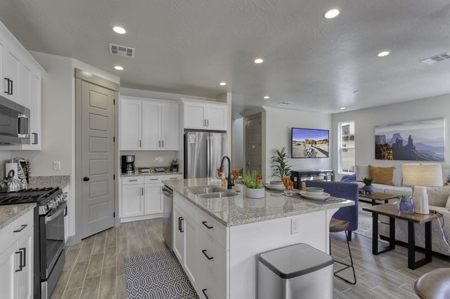Kitchen island and pantry opening to the great room at Escondido 2323