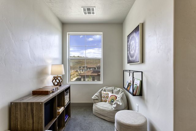 Cozy reading nook with lounge chair and bookshelf by a window