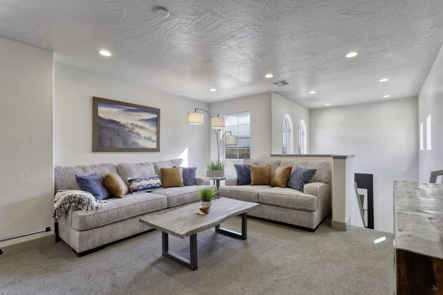 Upstairs loft sitting area with sofa and coffee table