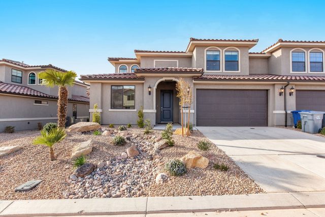 Front of Escondido 2343 with two-car garage and desert landscaping