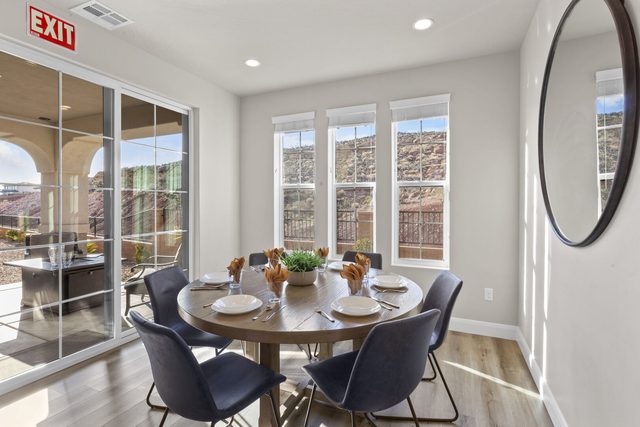Round dining table for six beside patio sliding doors in 2343