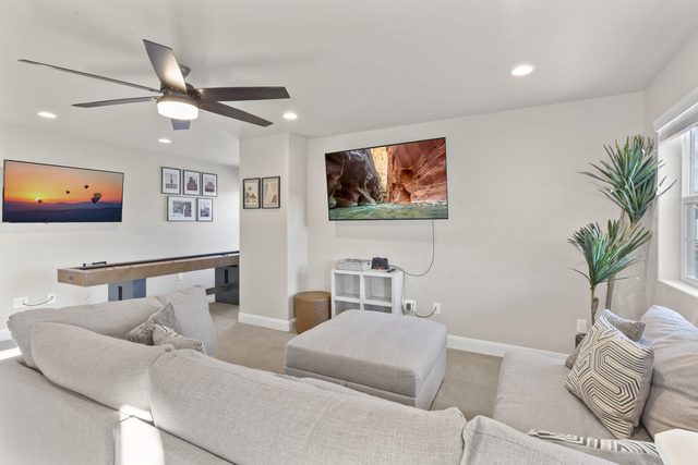 Upstairs loft with sectional, wall TV and shuffleboard table in 2343