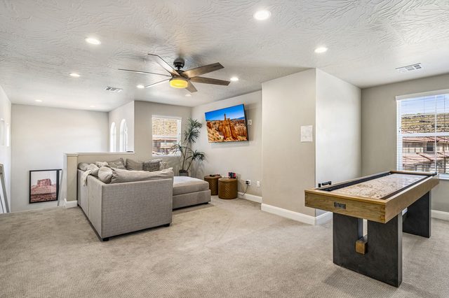Upstairs loft lounge with sectional, TV and shuffleboard table in 2355