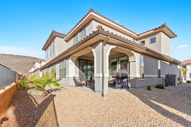 Rear of Escondido 2343 with covered patio and desert landscaping