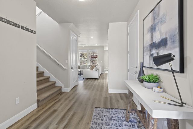 Entry hall with console desk and stairs to the upper level
