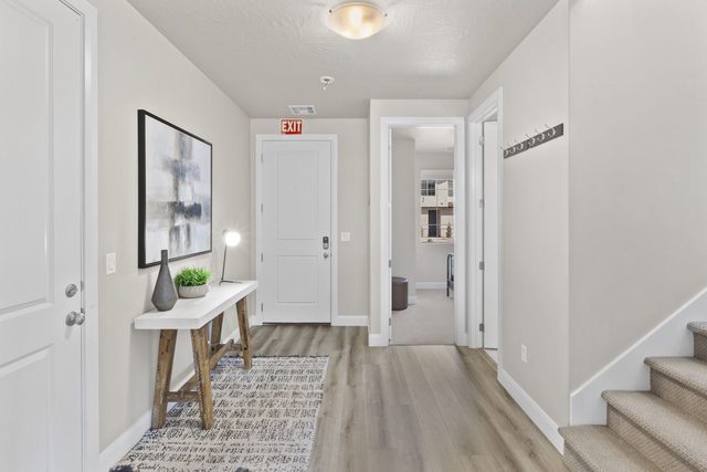 Front entry hall with runner rug and staircase