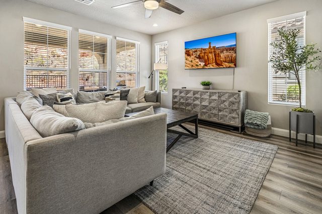 Living room sectional and wall-mounted TV at Escondido 2355