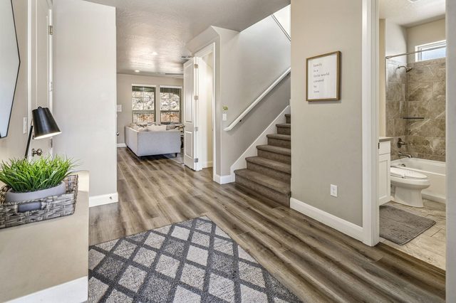 Entry hall with staircase and view into the great room