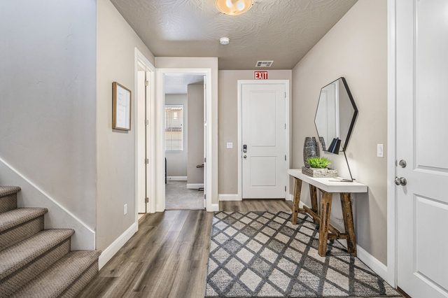 Front entry with console table, mirror and stairs to the upper level