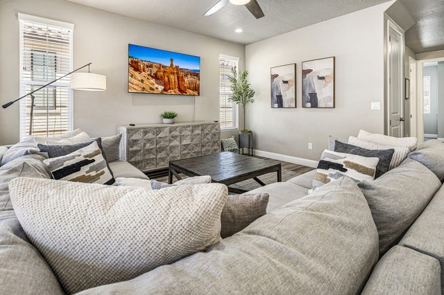Great room with large sectional, coffee table and smart TV
