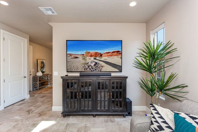 Living room TV console with red rock artwork on screen