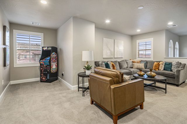 Upstairs loft with sectional, leather chair and arcade cabinet