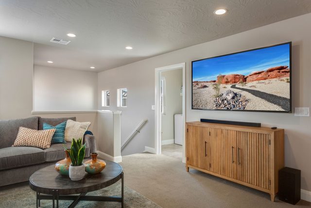 Loft seating area with TV and wood media console