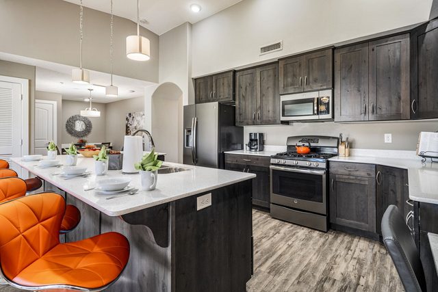 Kitchen with gas range, stainless appliances and island seating