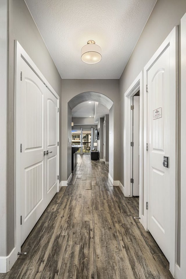 Entry hallway with wood-look flooring leading to the bedrooms