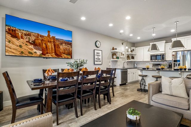 Dining table with kitchen and island beyond at Freedom Village 3955