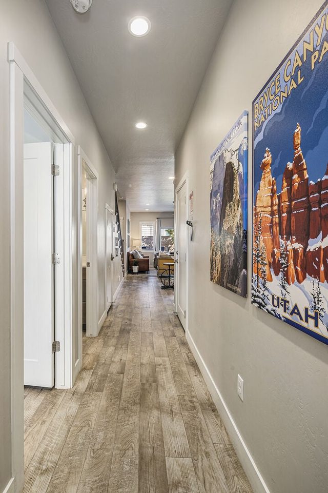 Hallway with Utah travel posters leading to the living room