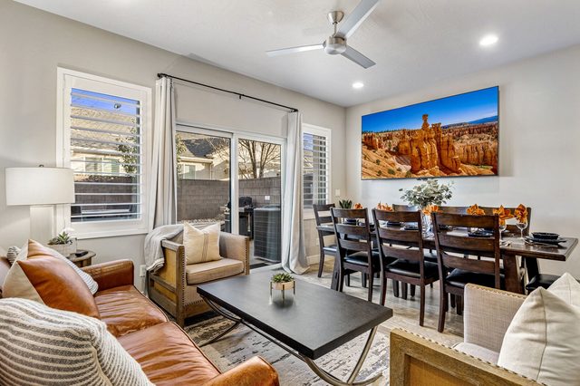 Living room with leather sofa, coffee table and dining area