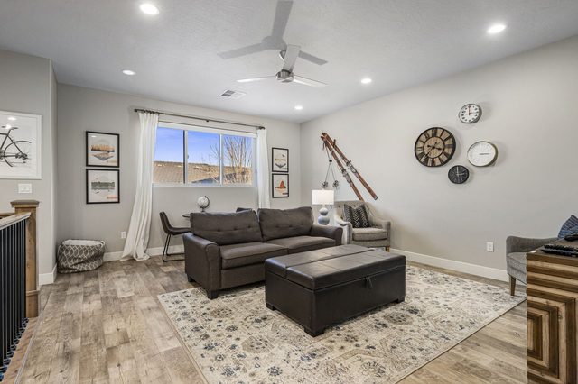 Upstairs loft with sofa, ottoman and wall clocks
