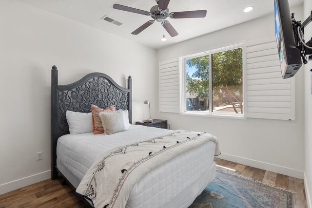 Home 523 bedroom with carved headboard bed and wall-mounted TV