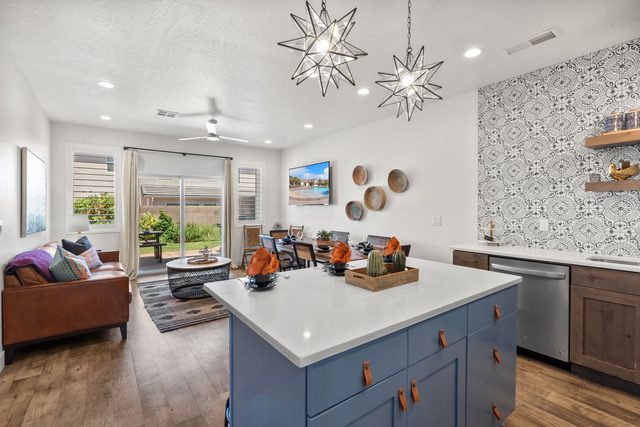 Home 523 kitchen island with blue cabinets and star pendant lights
