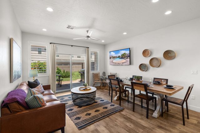 Home 523 living and dining area with leather sofa and patio door
