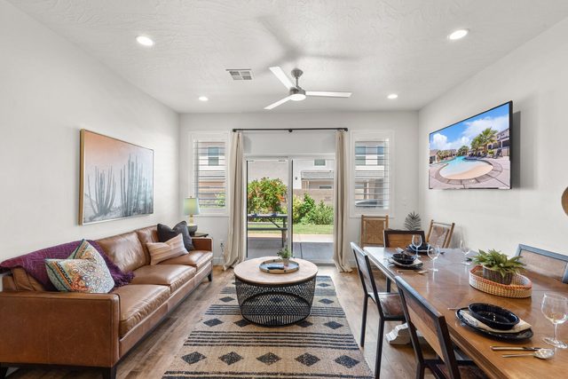 Home 523 living room with leather sofa, TV and patio slider