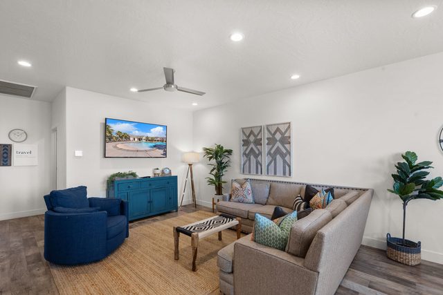 Upstairs family room with blue armchair and sectional seating