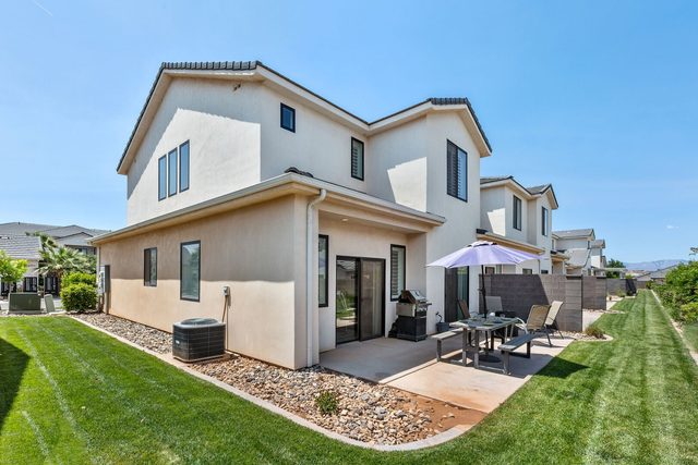 Rear exterior of Freedom Village 529 with patio and lawn