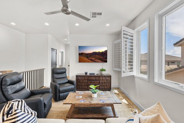 Upstairs family room with leather recliners and wall TV