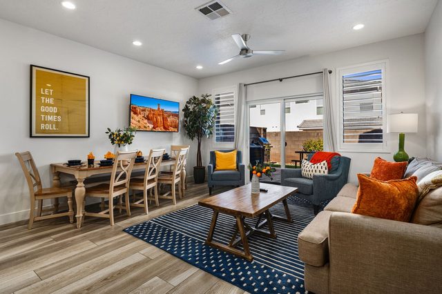 Living and dining area with sofa, TV and patio slider