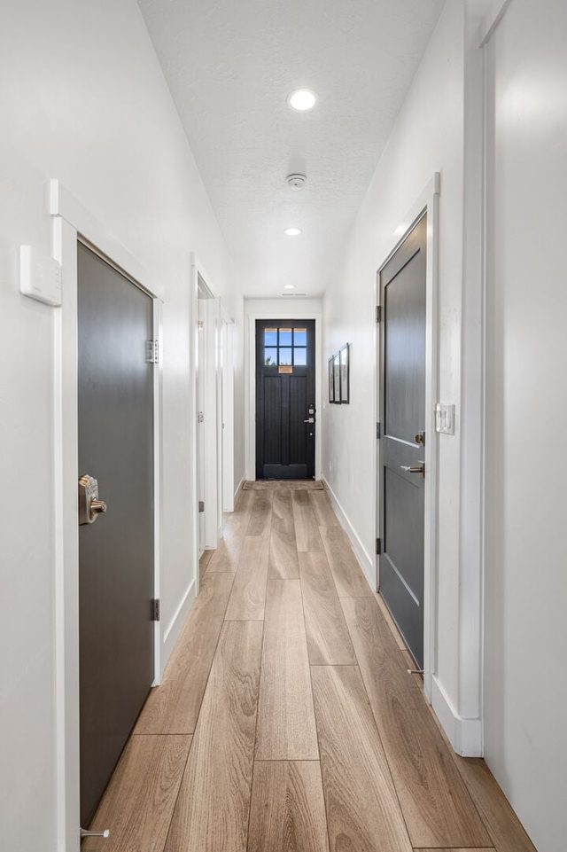 Entry hallway with wood-look floors toward the front door