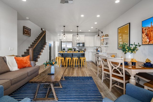 Great room with sofa, coffee table and kitchen beyond