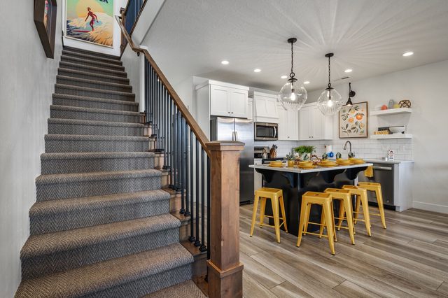 Carpeted staircase beside the kitchen island