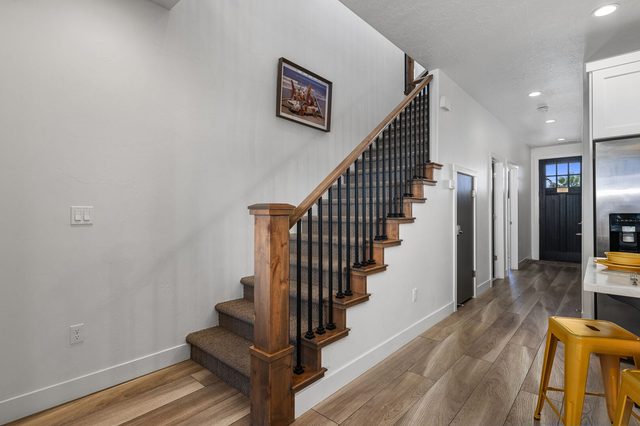 Staircase and hallway leading to the front door