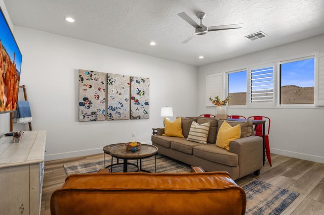 Upstairs loft with sofa, leather ottoman and games table