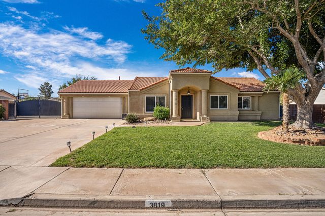Front exterior of Hurricane 3819 single-level home with lawn and garage