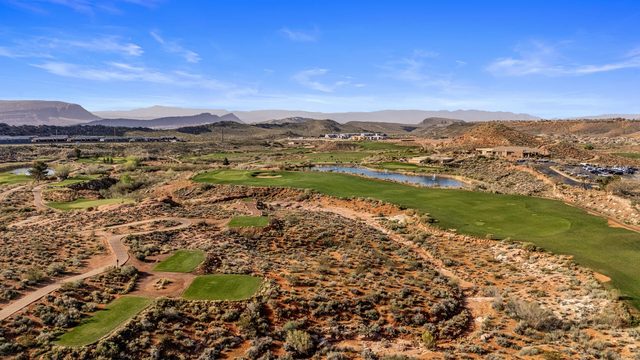 Aerial of a desert golf course with fairways and a pond