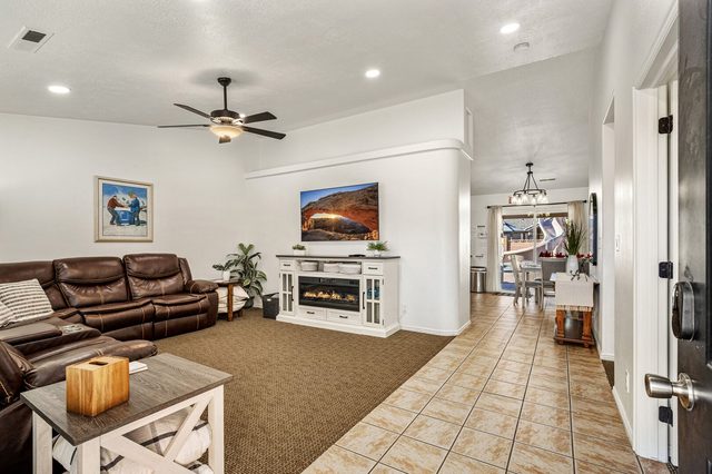 Living room with leather reclining sectional and electric fireplace