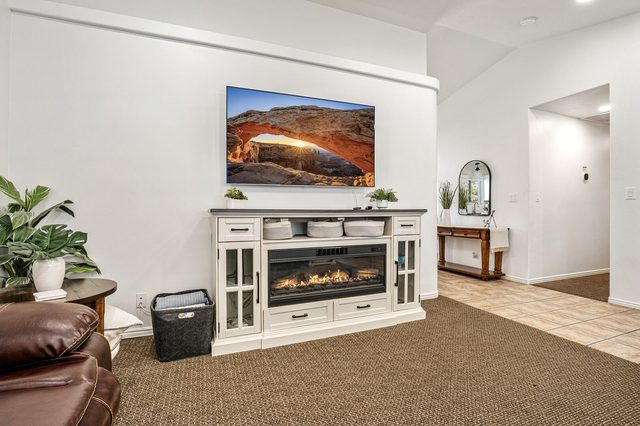 Electric fireplace media console with wall-mounted TV