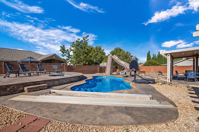 Private pool with safety cover track and water slide