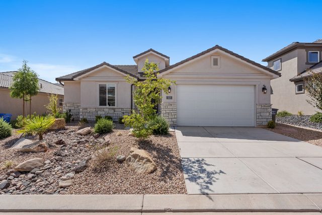 Single-story front of Ladera 325 with desert landscaping and garage