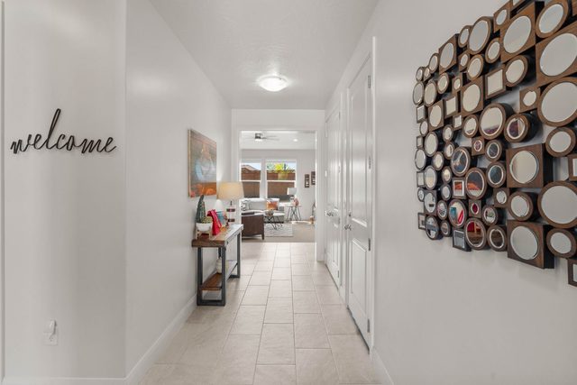 Entry hallway with welcome sign and decorative mirror wall