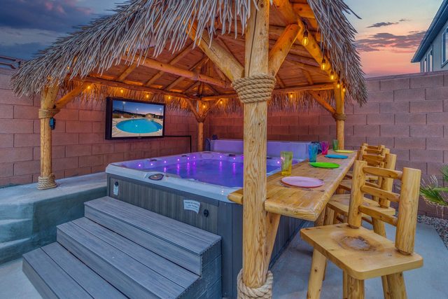 Private hot tub under the tiki hut with bar seating