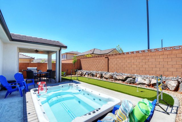 Swim spa and putting green along the backyard wall at Ladera 325