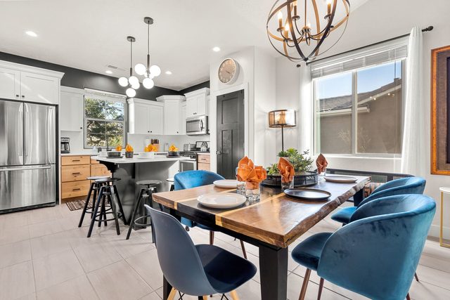 Dining table with blue chairs beside the kitchen island