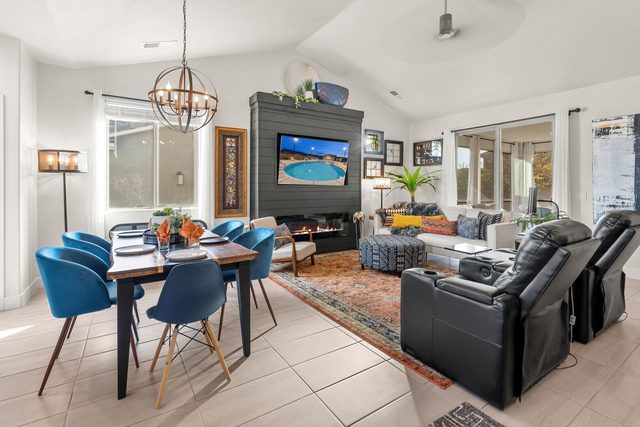 Dining area and great room with fireplace TV wall