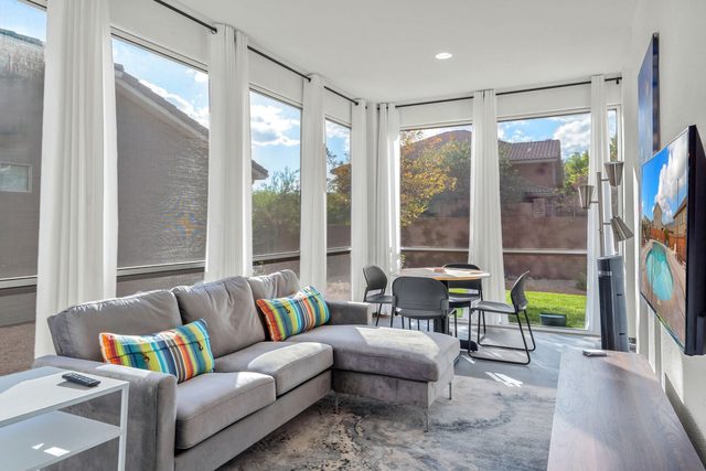 Sun room with sectional sofa, smart TV and game table